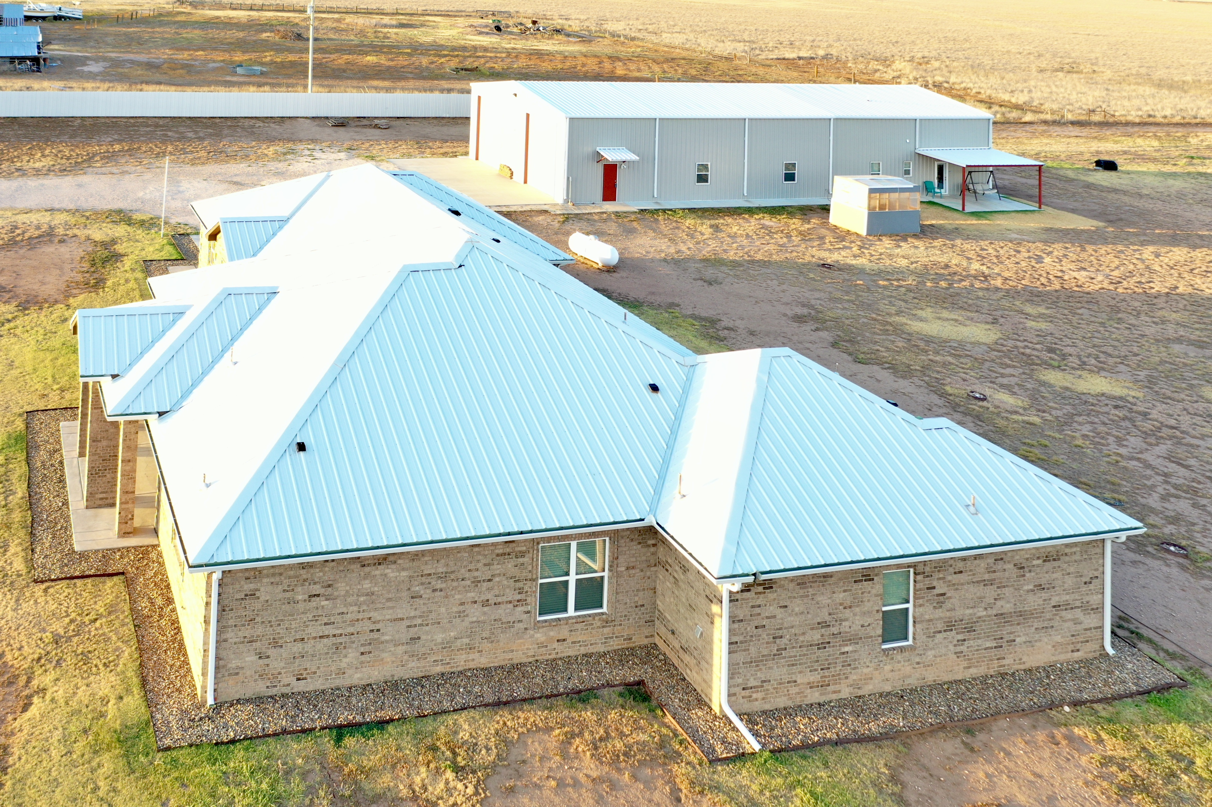 Main home with the connected shop and barndominium beyond